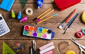 Art supplies on wood desk, Create an art studio for people with ADHD.