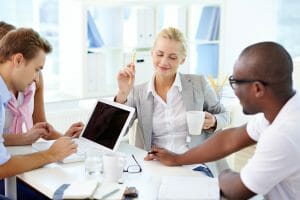 Young business team gathering in office to brainstorm