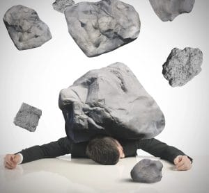 overwhelmed man under boulder barrage