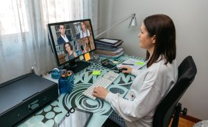 Woman having a video conference work meeting from home